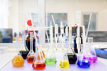 Chemical analysis, pharmacology and laboratory concept. Flasks with colored liquid reagents in a science laboratory