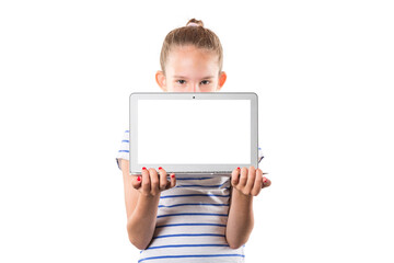 Cute little european girl holding modern silver laptop isolated on white background. Free space for your text on the display