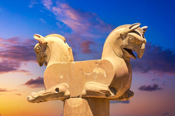 Old sculpture of two-headed Griffin in the ancient city of Persepolis, Iran during sunset