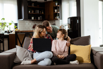 Family Bonding Time With Laptop in Cozy Home Setting