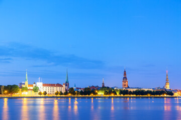 Sunset twilight view of Riga cityline panorama over river Daugava with old town.