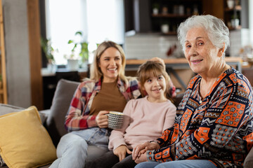 Generational bonding, grandmother, daughter, and grandchild sharing stories on a cozy afternoon