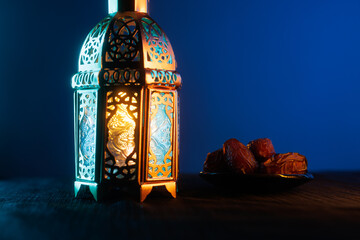 Ornamental Arabic lantern with burning candle glowing at night.Festive greeting card, invitation for Muslim holy month Ramadan Kareem.