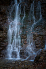 Fototapeta na wymiar a waterfall in long exposure photography in the mountains
