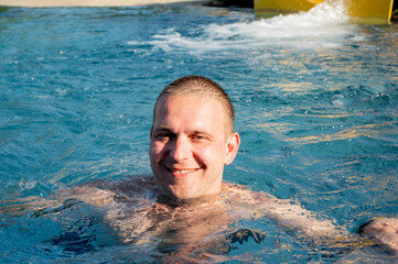 Man relaxing in swimming poll. 