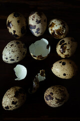 Quail eggs with one broken showing shell texture