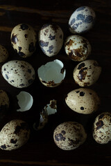 Quail eggs with one broken showing shell texture