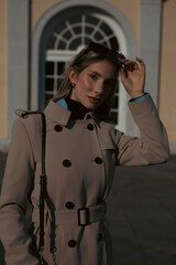 wunderful sporty woman with blond hair well dressed in park at first sunshine of the year in the city