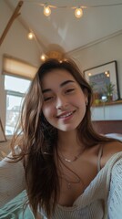 Young attractive woman standing in room at home taking selfie smiling