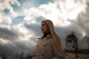 wunderful sporty woman with blond hair well dressed in park at first sunshine of a year