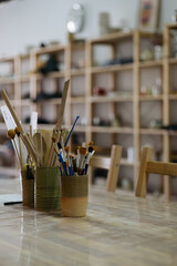 Artistic Pottery Studio Interior with Ceramic Tools and Brushes on a Work Table