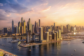 Panoramic view of the modern skyline of Dubai Marina with skyscrapers reflecting the warm sunset...