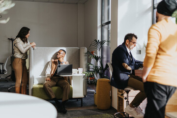 Different aged employees collaborating and discussing business ideas in a modern office. Working together for a successful project.