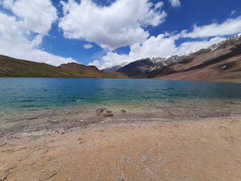 lake in the mountains with white clouds and blue sky (Chandra Taal Lake)