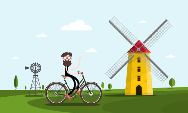 Man on bicycle with windmills on background