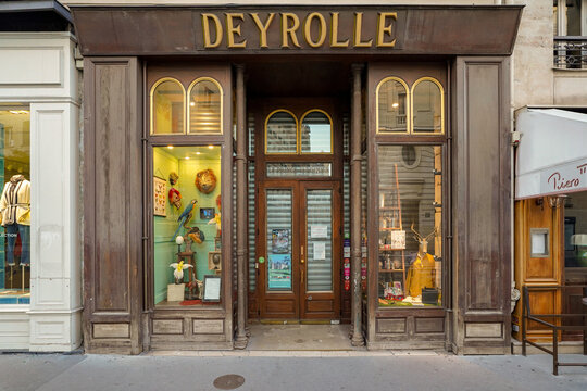 Paris France 9 july 2023 : traditional and typical french boutique storefront painted in brown