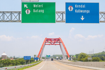Trans Java Toll Road with signs bearing the names of destination cities Weleri and Batang on the...