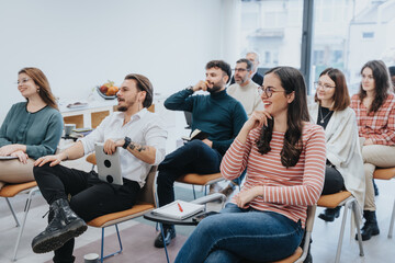 A group of people attentively listening and interacting at a casual, modern business seminar. The atmosphere is relaxed and cheerful, with participants engaging enthusiastically.