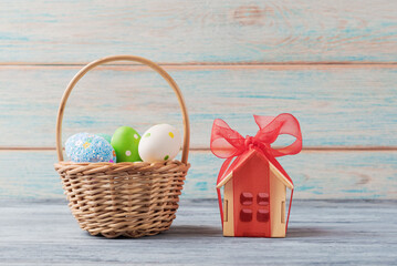 Easter Eggs and House-Shaped Gift Box on Wooden Background - 747566364
