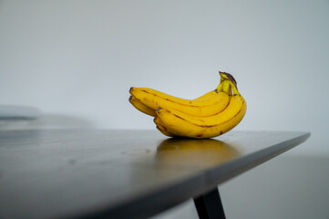 Daytime radiance: banana poised on the sunlit kitchen surface
