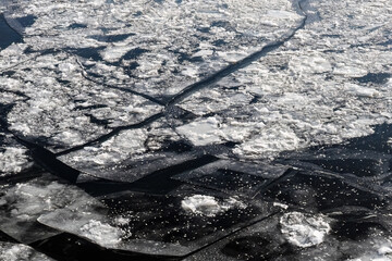 ice drift on the river. Ice Floes in dark water © Konstantin