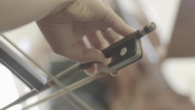 Girl Playing The Cello. The Bow Moves On The Strings Of A Cello.