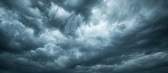 A wide expanse of grey storm clouds engulfs the sky, creating a breathtaking banner image. - obrazy, fototapety, plakaty