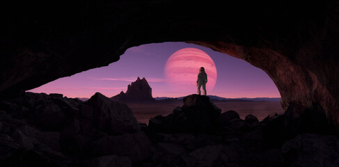 Astronaut standing in cave with Sci-fi Scene of Alien Planet Rocky Terrain with Background Jupiter planet