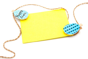 Greeting blank card with rope on clothespins with colored eggs. Copy space. Free space for text. Happy easter!