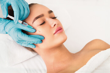 Beauty procedure. Woman receiving hyaluronic acid injection