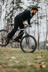 A focused man enjoying a bike ride in a park setting while wearing headphones, showcasing an active lifestyle and outdoor leisure activity.