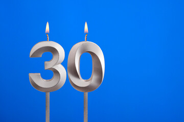 Birthday candle number 30 - Celebration card on blue background