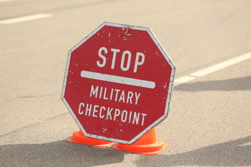 Military checkpoint sign on the asphalt road