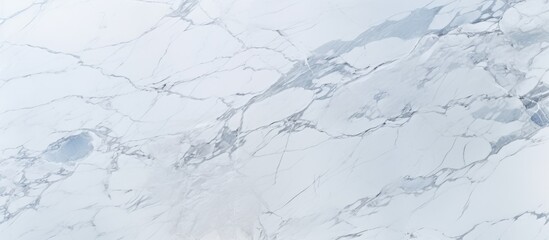 A detailed view of a pristine white marble surface, showcasing the intricate veins and patterns that make it a popular choice for ceramic surfaces and backgrounds.