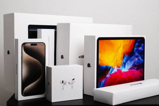 BERLIN , GERMANY - FEBRUARY 14 2024: IPhone, Air Pods Pro. iPad and Apple watch boxes standing on the black table.