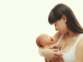 Happy mother holding cute infant, baby sleeping in arms on white studio background