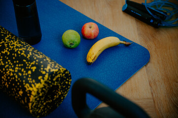 A combination of kiwi, almonds, and a gym towel on the mat. Nourishing the body during a dedicated workout - 747593511