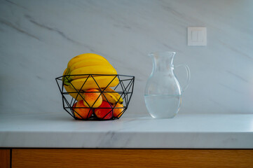 A banana in a glass bowl captures the essence of daylight on the kitchen counter - 747594143