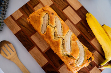 Banana bread and a fresh banana placed on the kitchen counter