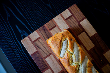 Daylit kitchen display featuring banana bread and a fresh banana on the counter
