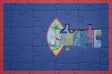 puzzle with the national flag of guam and euro banknote. finance concept