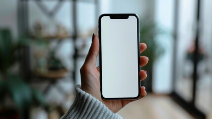 Close-up hand holding a phone with a blank white screen turned towards the camera