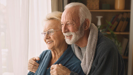 Embraced elderly couple at home