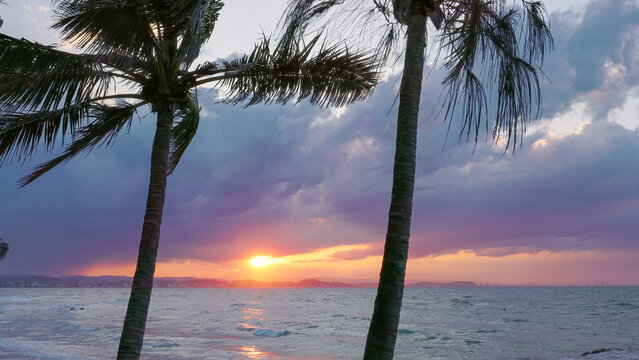 a shot of the sun setting looking from greenmount beach in coolangatta towards the gold coast in queensland, australia