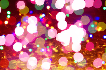 Colorful defocused bokeh lights  blur red pink sparkling background Gold lights Golden sparks...