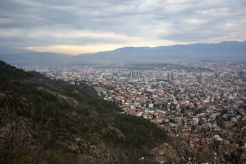 European mountain city seen from above at sunset on a cloudy day, Skopje the capital city.