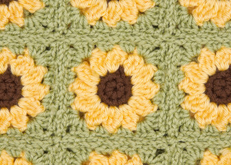Close up on finished connected crochet sunflower granny squares showing blanket.