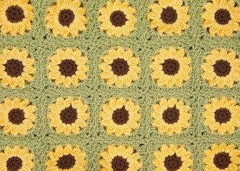Close up on finished connected crochet sunflower granny squares showing blanket.