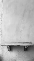 A monochrome photo showing a wooden bench placed against a wall, creating a simple contrast of light and shadow.
