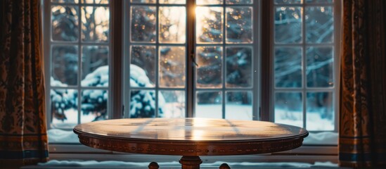A wooden table is placed in front of a window showcasing a winter view in the background.